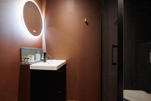 a bathroom with a sink and a mirror and a shower at Love Room Marseille - Aphrodisia in Marseille +11 photos