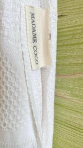 a close up of a white curtain on a bed at Akdeniz Villa in Kas