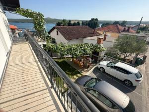 a white car parked on the balcony of a house at Apartment Bonaca in Posedarje