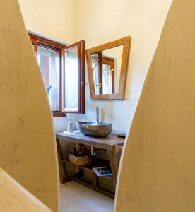 a bathroom with a counter with a sink and two mirrors at La Casa nel Borgo in San Felice del Benaco +35 photos