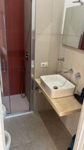 a bathroom with a sink and a shower at FAZIO ROOMS Roma in Rome