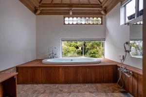 a large bathroom with a large tub in a window at 旧邸貸別荘 南壽庵 in Tateyama +40 photos