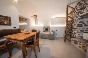 a living room with a table and a couch at Porta Bormina Loft&Suites in Tirano
