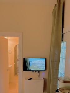 a flat screen tv on the wall of a bathroom at Sattva Home in Charlottesville