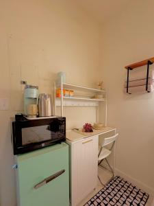 a small kitchen with a microwave and a counter at Sattva Home in Charlottesville