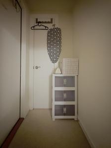 a hallway with a dresser and a door with a curtain at Sattva Home in Charlottesville