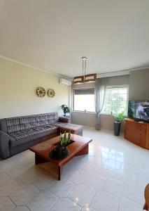 a living room with a couch and a table at Erofili's Apartment ONLY 700 meters from the beach in Ialyssos