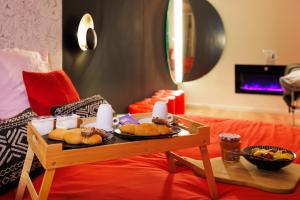 a table with two plates of food on top of a couch at Love Room Marseille - Orion in Marseille +14 photos
