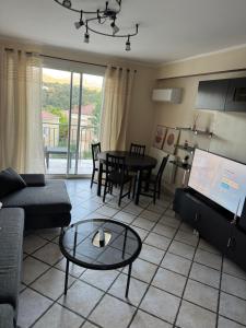 a living room with a couch and a table at Appartement T4 in Corte