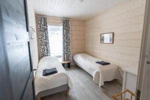 a small room with a bed and a window at The Copper Nest by Hilla Villas in Saariselka
