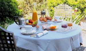 a table with a blue table cloth with fruit on it at La Martanne in Argelès-sur-Mer