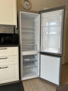 einem leeren Kühlschrank mit offener Tür in der Küche in der Unterkunft Ruhrperle Apartment 1 Essen in Essen