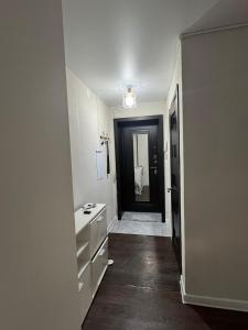 a bathroom with a white sink and a black door at Квартира на Протозанова 39 in Ustʼ-Kamenogorsk +6 photos