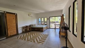 a living room with a bed and a room with a door at 4 Amigos El Zonte in El Zonte +12 photos