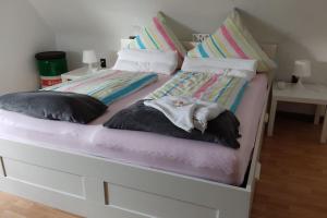 a white bed with two pillows on it at Hübsche 2 Zimmerwohnung in Kaarst