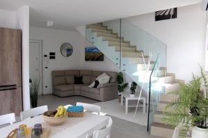 a living room with a staircase and a couch at Magnolia in Francavilla al Mare
