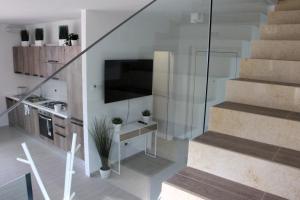 a room with a staircase with a sink and a kitchen at Magnolia in Francavilla al Mare