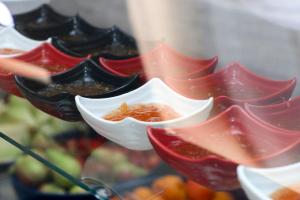 a display case with a bunch of bowls of food at Kompleksi Muja in Velipojë +16 photos