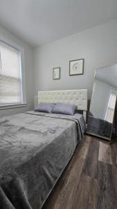 a bedroom with a large bed and a window at Serenity Haven in Irvington