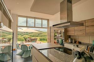 a kitchen with a counter and a table with chairs at La Bastide in Puycalvel Lautrec