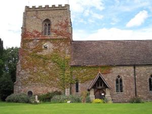 an old brick church with a tower with ivy on it at The Piggery, located at the foot of the Malvern's in Mathon +5 photos