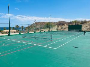 a tennis court with two tennis nets on it at Rancho De Costa by Cabo Villas in La Paz