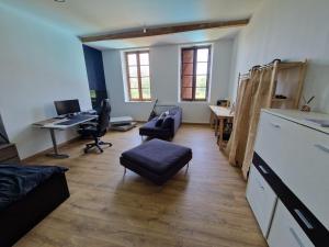 an office with a desk and chairs and a table at la roulotte dépote in Monbéqui