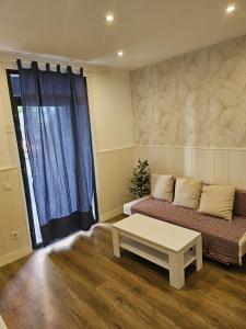 Una sala de estar con un sofá y una mesa de café. en Hogar en Lavapies 11, en Madrid