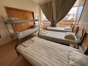 Postel nebo postele na pokoji v ubytování Garden Hostel