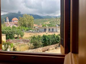 a view from a window of a town at Bright Cozy Home with Terrace, Garden & Sea View in Neokhórion +26 photos