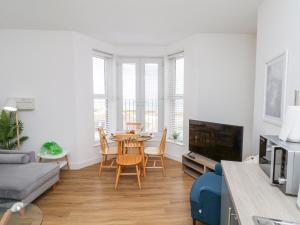 a living room with a table and a couch at Glenholme Apartment 3 in Redcar