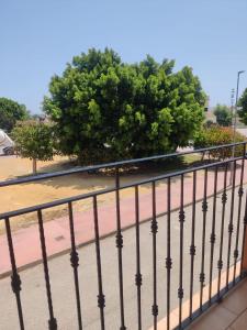 a black fence with a tree in the background at Petit Santa Lucía in Catral