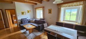 a living room with a couch and a table at HOCHFICHTBLICK Apartments in Ulrichsberg