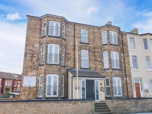 a large brick building with white windows at Glenholme Apartment 6 in Redcar