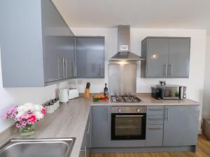 a kitchen with a sink and a stove top oven at Glenholme Apartment 6 in Redcar