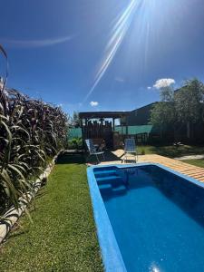 a small swimming pool in a yard with a yard at Cabaña La Nazarena in Capilla del Señor