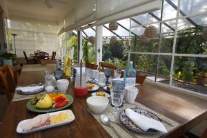 a wooden table with plates of food on it at Gerthrudes Bed & Breakfast in Rio de Janeiro