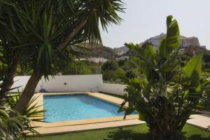 a swimming pool in a yard with trees at Fantástica Casa Adosada con Piscina y Parking in Mojácar