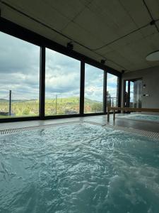 a large swimming pool with a view of the ocean at TatryTop Słoneczna Rezydencja Jacuzzi & Sauna in Białka Tatrzanska