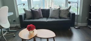 a living room with a blue couch and a table at Elegant 2BR & 2BA Retreat in Prime Yorkville, Downtown in Toronto +20 photos