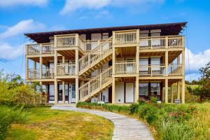 aominium building with a walkway in front of it at Seashore Escape in North Truro