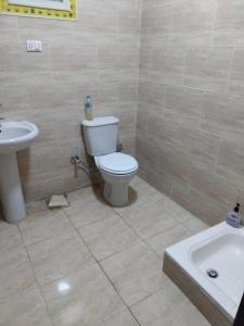 a bathroom with a white toilet and a sink at Home in ras sedr in Ras Sedr