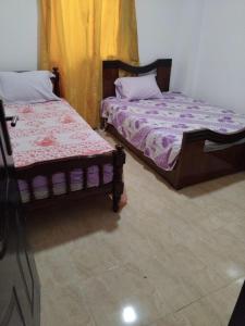 two beds sitting next to each other in a room at Home in ras sedr in Ras Sedr