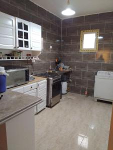 a kitchen with a stove and a sink in it at Home in ras sedr in Ras Sedr