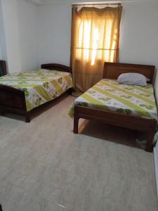 a bedroom with two beds and a window at Home in ras sedr in Ras Sedr