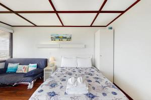 a bedroom with a bed and a couch at The Pagoda Perch in North Truro