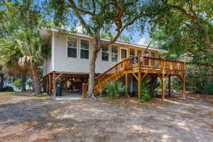 a house with a wooden deck in front of it at AJ's Happy Place in Edisto Island