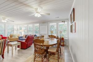 a living room with a table and chairs and a couch at AJ's Happy Place in Edisto Island