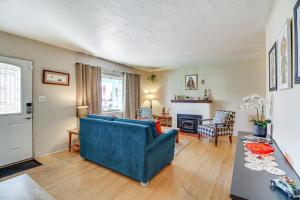 a living room with a blue couch and a table at Dog-Friendly Albuquerque Home 1 Mi to U of NM! in Albuquerque +19 photos