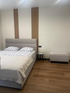 a bedroom with a white bed and a table at Style Apartament-studio, ЖК КиївСкай in Lutsk